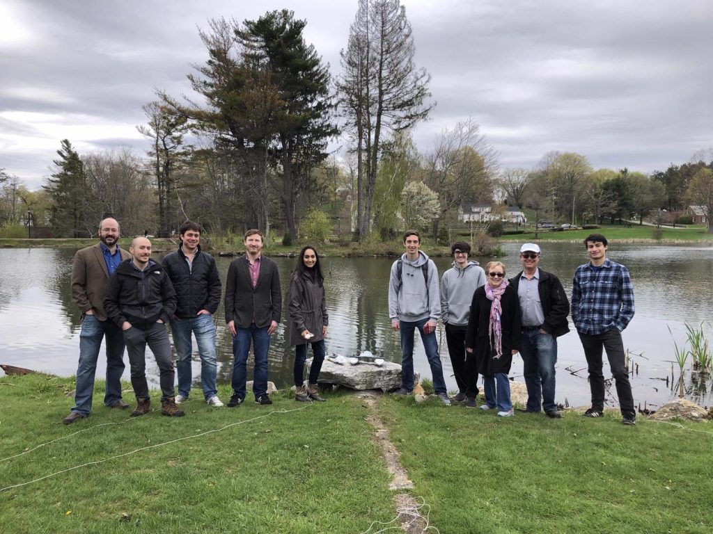 students standing in front of a lake