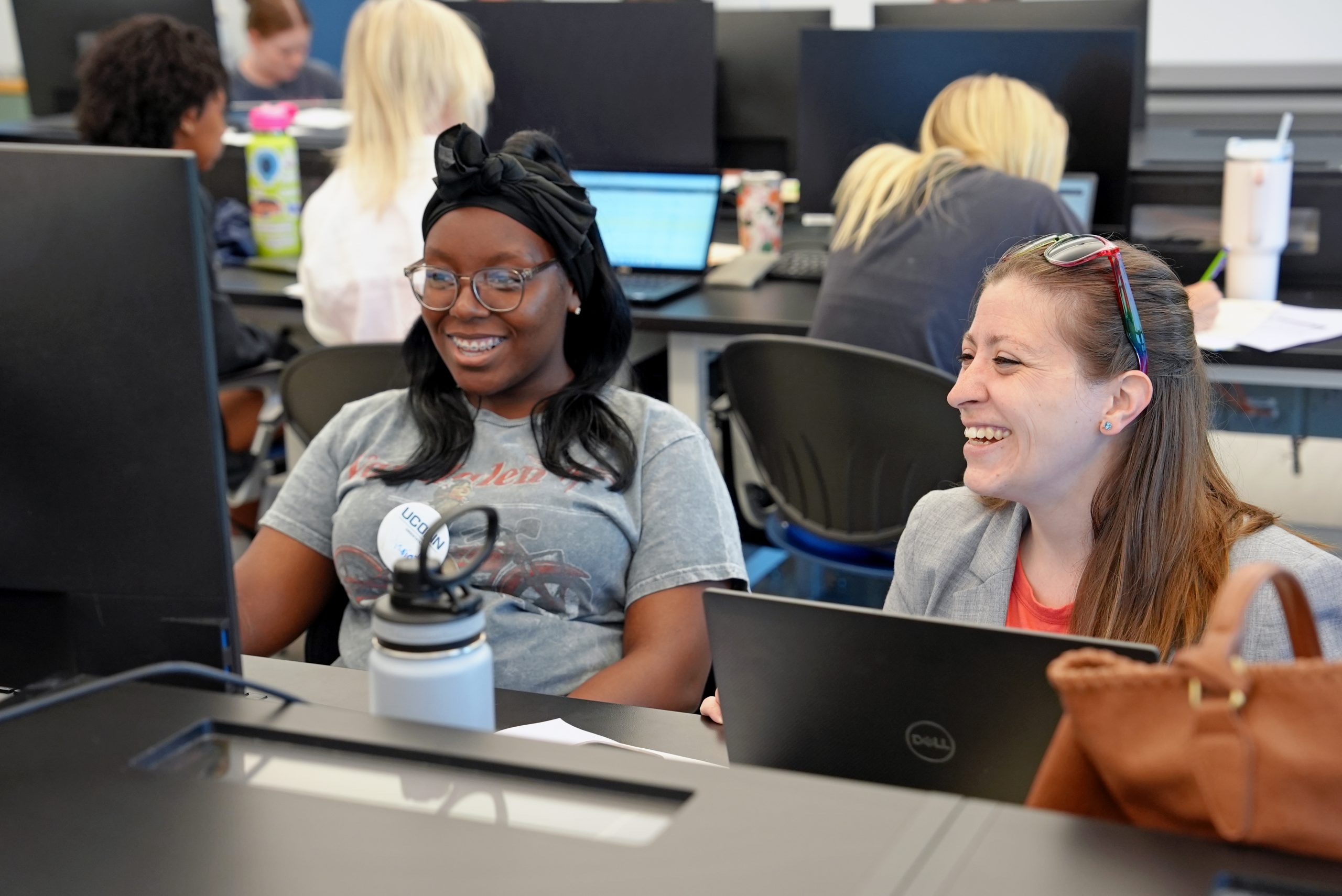 two female undergraduate students in front of a computer